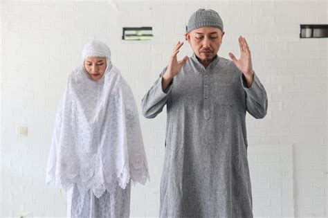 Premium Photo Muslim Man Leading His Wife Doing Salat Together With