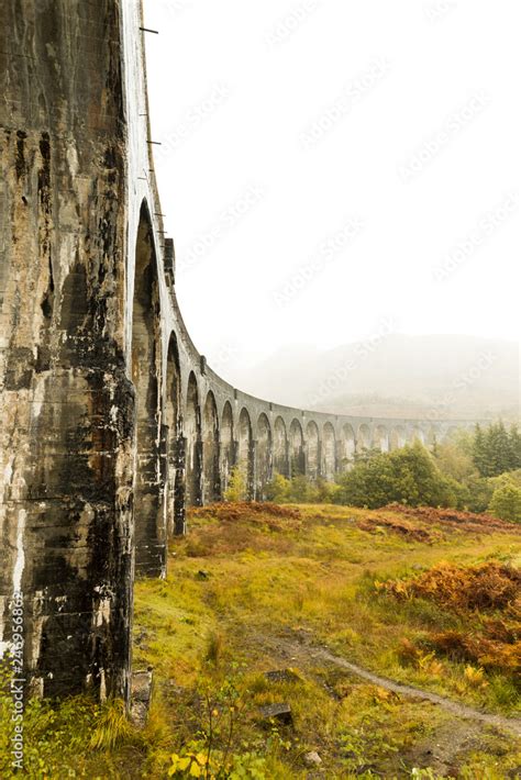 Glenfinnan Viaduct as seen from below during a hike to spot the famous steam train in autumn ...