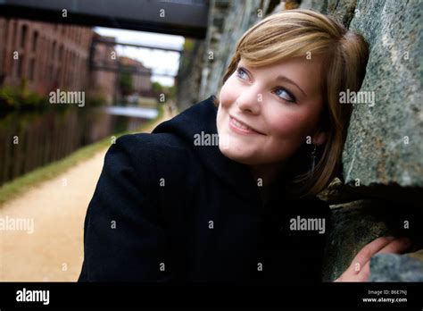 Young Caucasian Female Blond Leaning On Rock Wall Stock Photo Alamy