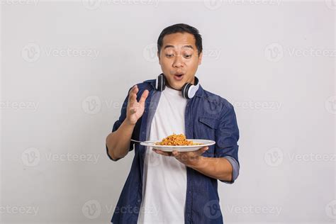 Asian Man Eating Instant Noodle And Feel Surprise With How Delicious It