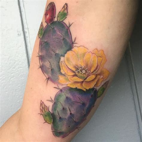 A Watercolor Style Cactus And Flower Tattoo On The Right Arm With Ladybug