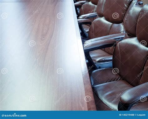 Brown Leather Chairs Around Wood Conference Room Table Desk Stock Photo