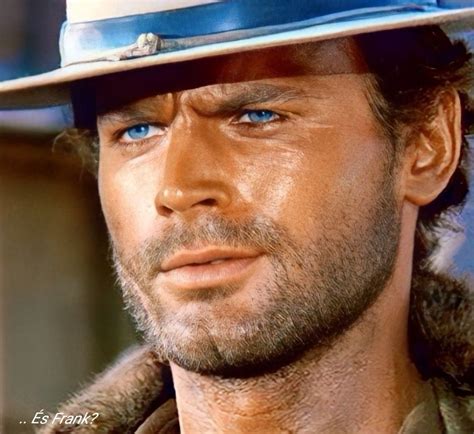 A Close Up Of A Man Wearing A Hat With Blue Eyes And A Goatee