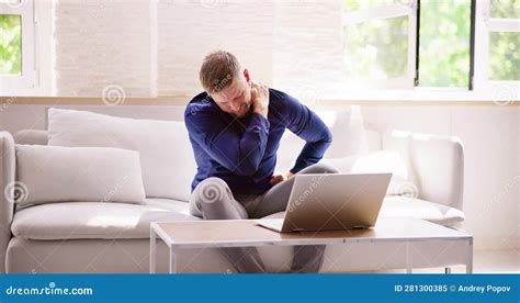 Man Working On Laptop Computer With Neck Injury Pain Stock Image