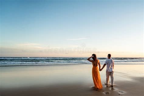 Romantic Couple Walking On Sunset Beach Enjoying Evening Light