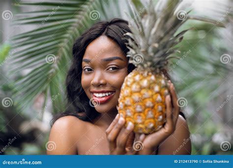 Portrait Of Charming Naked African American Woman With Pineapple In Her Hands Smiling To Camera