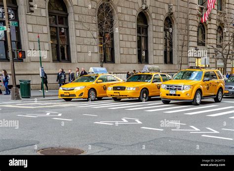 Yellow Taxi Cabs Three Different Types Of Cars Waiting For The Traffic Light To Turn Green