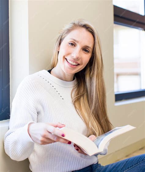 Premium Photo Young Adult Pretty Blonde Woman Reading A Book At Home