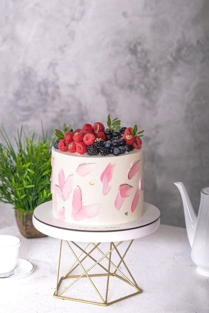 Premium Photo | Pink cake decorated with melted white chocolate macaroons