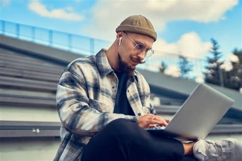 Premium Photo Serious Bearded Man In Glasses Works On Pc Freelancer