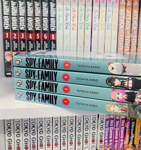 A Stack Of Books Sitting On Top Of A White Book Shelf Next To Each Other