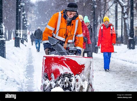 Russia Moscow A Utility Worker Clears Snow In A Street During A