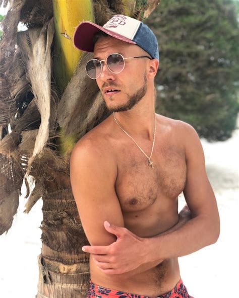 Premium Photo Shirtless Man Wearing Sunglasses While Standing Against Tree Trunk