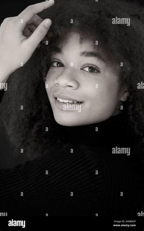 Portrait Of Attractive Smiling Curly African American Woman In Black