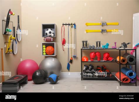 Many different sports equipment in room with beige walls Stock Photo - Alamy