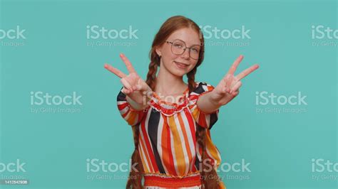 Redhead Lovely Girl Showing Victory Sign Hoping For Success And Win