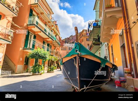 Traditional Colorful Houses And A Traditional Fishing Boat On A Narrow