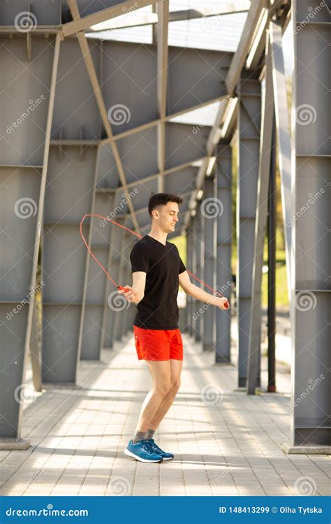 Young Man Skipping With Jump Rope Outdoors Exercising And Lifestyle