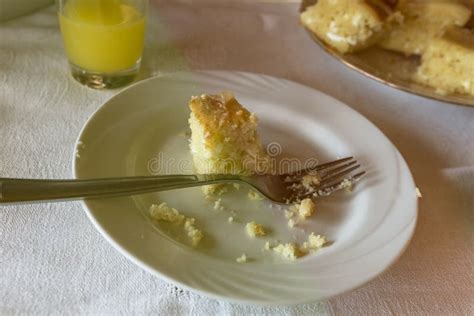 Dessert Fork And A Small Pie In A Glass Of Orange Juice Stock Photo