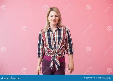 Woman With Long Blonde Hair Standing Isolated Over Pink Background