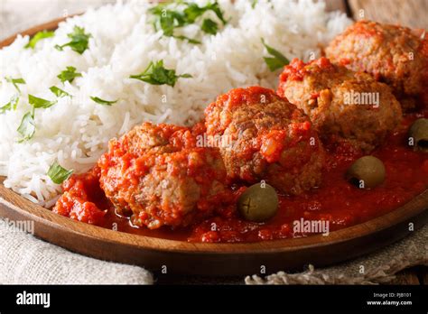 Traditional Soutzoukakia Recipe Greek Baked Meatballs In Tomato Sauce With A Side Dish Of Rice