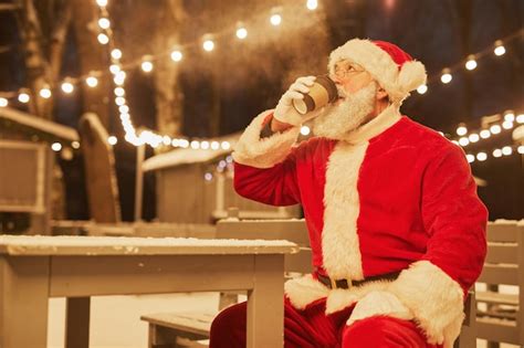 Premium Photo Portrait Of Traditional Santa Claus Drinking Hot Cocoa