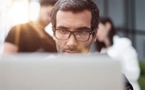 Premium Photo Portrait Of Handsome Bearded Man Wearing Glasses Working With Laptop In Office