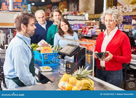 Senior Woman Paying At Checkout In The Supermarket Stock Image Image