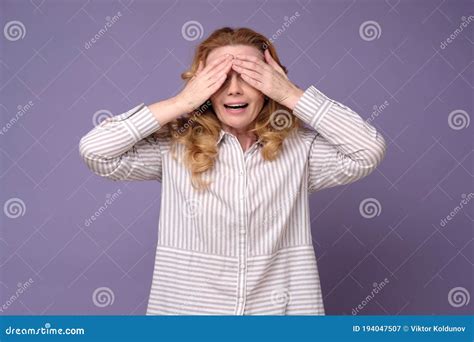 Caucasian Mature Woman Covering Eyes Waiting For Surprise Stock Image