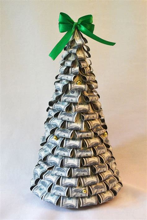 A Small Silver Christmas Tree Made Out Of Metal Cans With A Green Bow