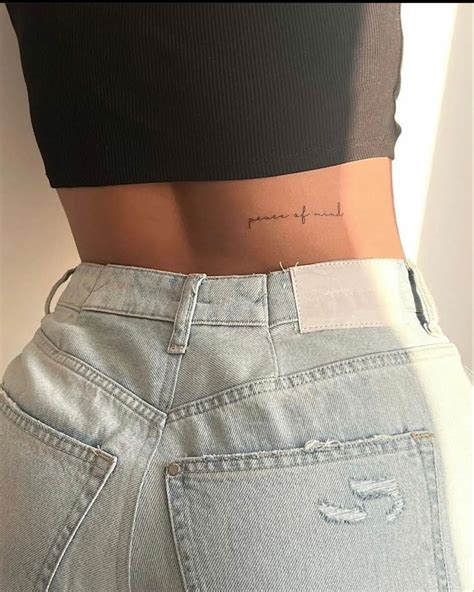 The Back Of A Woman S Stomach With Her Name Tattooed On It