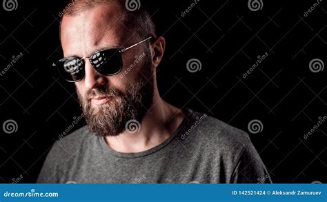 Portrait Of A Handsome Balded Man With Long Well Trimmed Beard Wearing