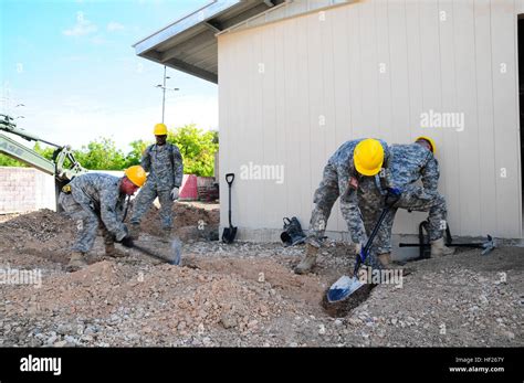 Members of the 358th Engineer Company expand a ditch at the construction site in the ...