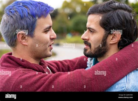 Latin Gay Couple Hugging In A Park Looking At Each Other About To Kiss Stock Photo Alamy