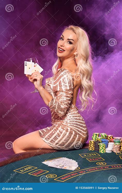 Blonde Woman With A Perfect Hairstyle And Bright Make Up Is Posing With Playing Cards In Her
