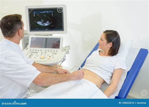 Pregnant Woman Receiving Ultrasound Treatment In Hospital Stock Photo