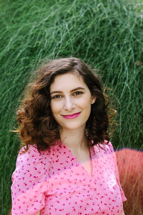 Portrait Of A Beautiful Smiling Woman In Front Of The Green Background