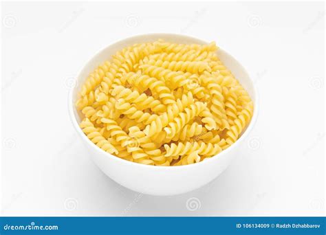 Pasta Spiral Or Fusilli Close Up In White Bowl White Background Stock