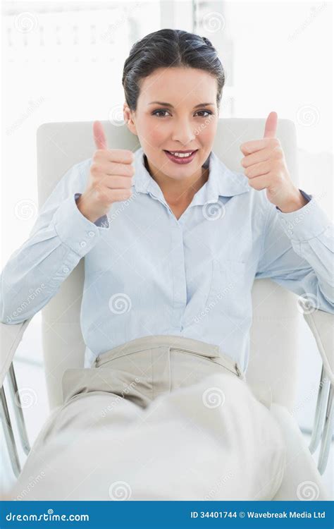 Content Stylish Brunette Businesswoman Giving Thumbs Up Stock Photo
