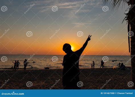 Silhouette Of A Male Holding Hands On The Beach At Sunset Stock Photo ...