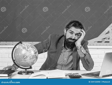 Mature Bearded Man Teacher In Costume Sit In School Classroom With Geography Globe Map