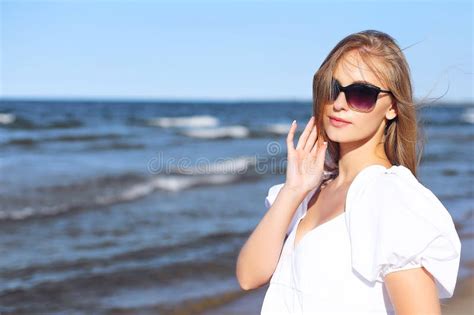 Happy Smiling Blonde Woman Is Posing On The Ocean Beach With Sunglasses Stock Image Image Of