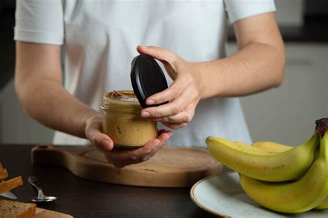 Premium Photo Peanut Butter In Woman Hands In The Kitchen