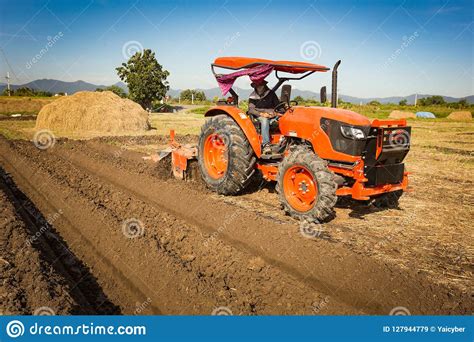 Tractor Plows A Field In The Spring Accompanied By Tractor Stock Image