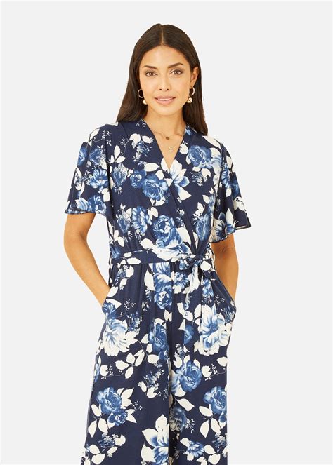 Mela Rose Print Jumpsuit With Angel Sleeves In Navy Matalan