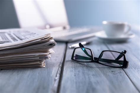 Premium Photo Newspapers With Glasses And Laptop