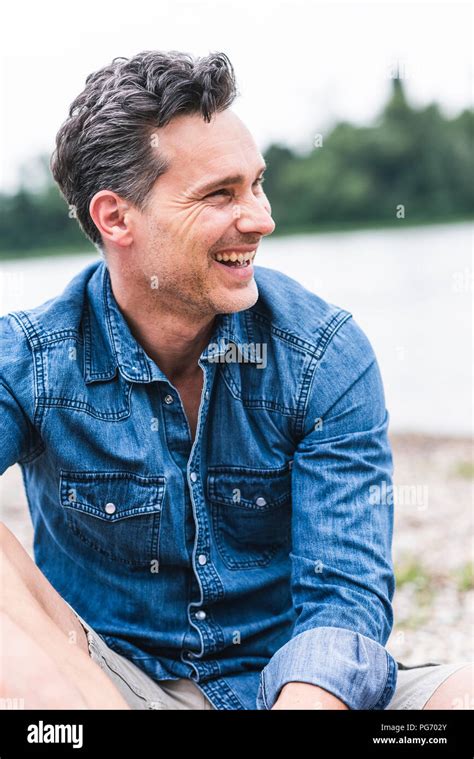 Laughing Man At The Riverside Looking Sideways Stock Photo Alamy