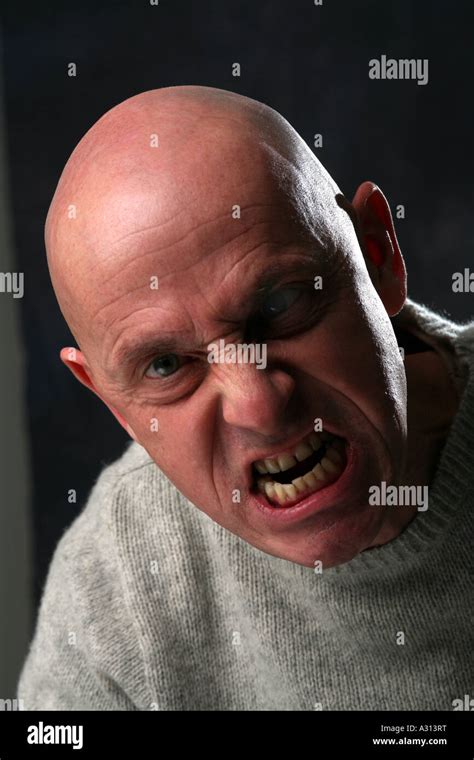 Studio shoot of angry bald man Stock Photo - Alamy