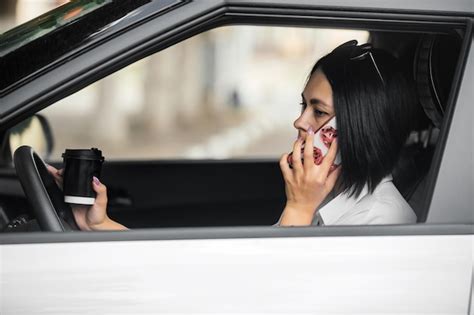 Premium Photo Beautiful Brunette Driver Sits In Her Car Drinking