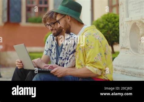 Close Up Gay Couple Hang Out Sitting Outdoors Use Phone Hugging Smiling Relationship Romantic